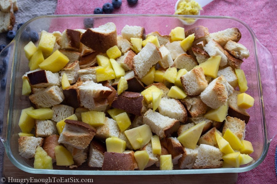 Image of bread cubes and mango in a pan
