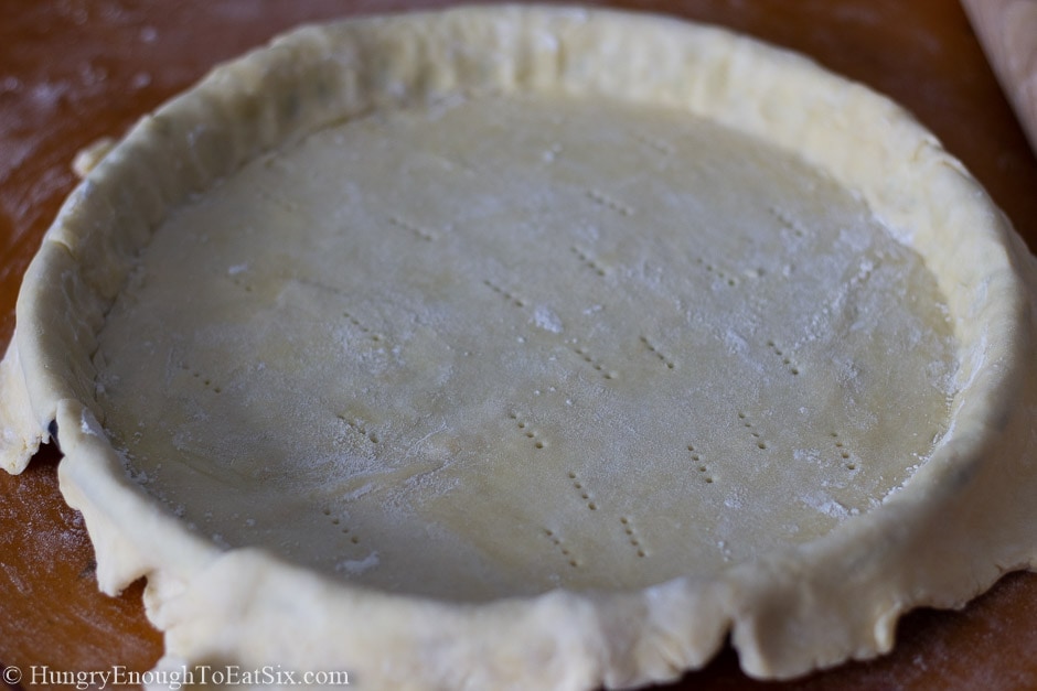 Pastry dough fit into a tart pan and pricked all over.