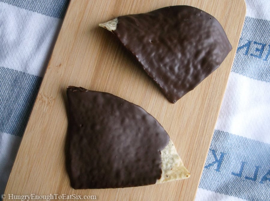 Two tortilla chips coated in chocolate.