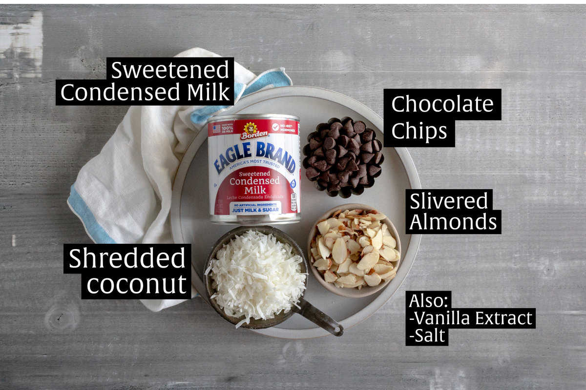 Ingredients like sweetened condensed milk, chocolate chips, coconut, and almonds.