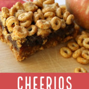 Cheerios and apple fruit bars on a wood board