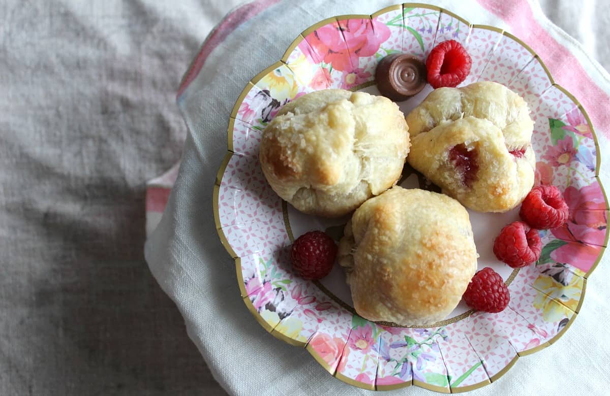 pastry puffs with raspberries and rolo candies.