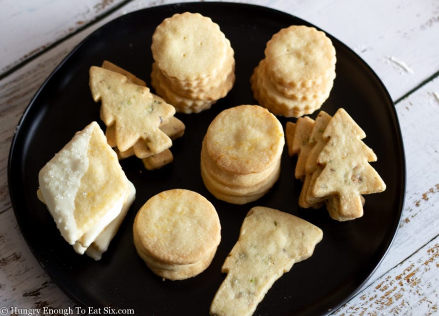 Stacks of butter cookies on a black plate
