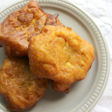 Three pumpkin fritters on a small gray plate