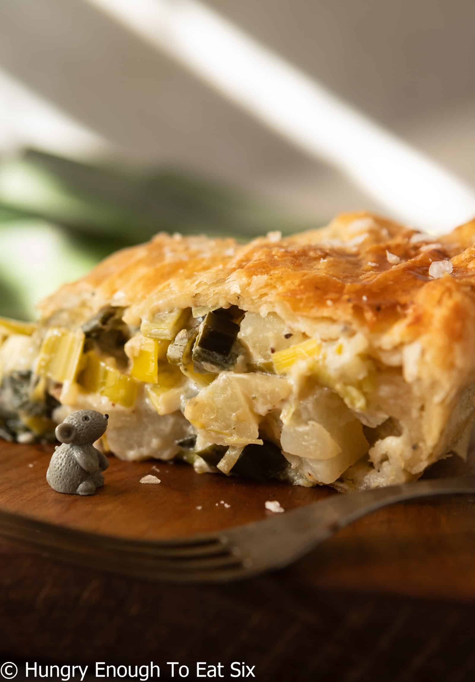 Side view of a leek and potato pie slice.