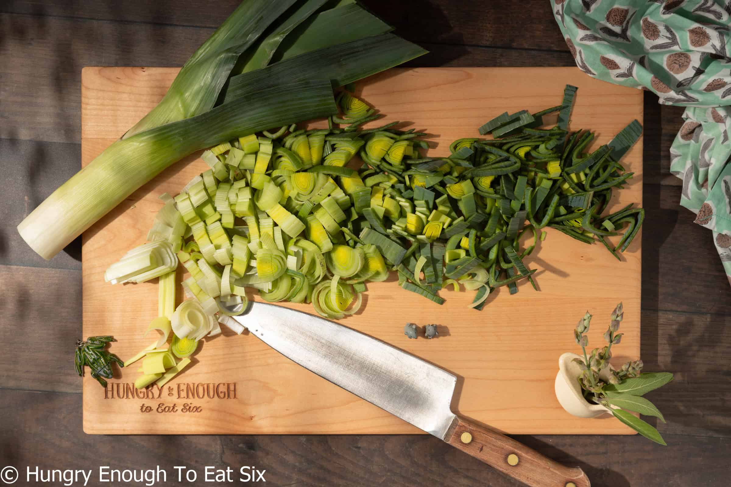 Sliced leeks on a cutting board, prepped to go into a leek potato pie.