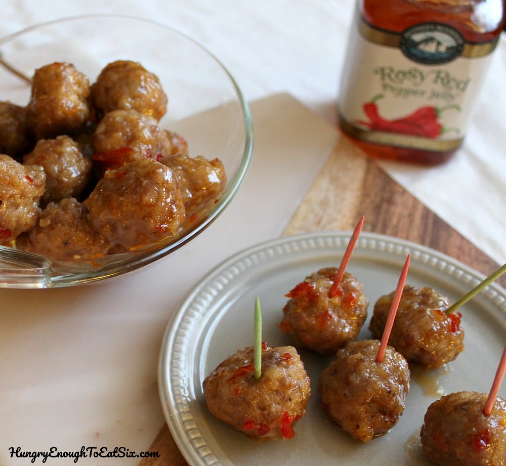 Meatballs with toothpicks on a grey plate.