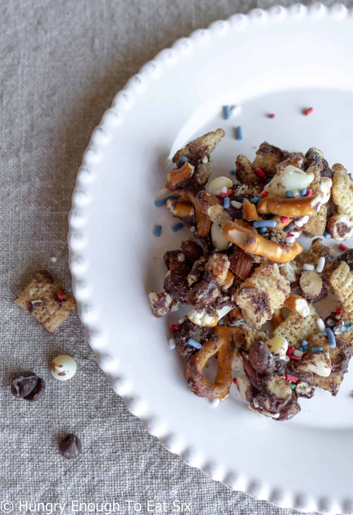 Snack mix with pretzels, cereal, and chocolate.