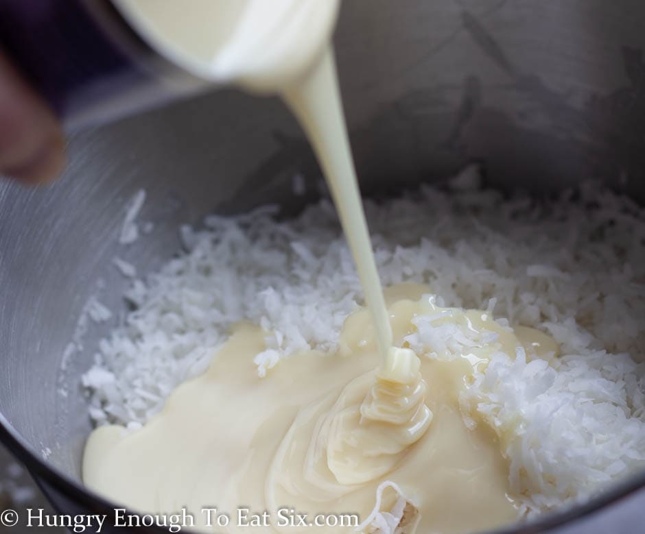 Bowl of coconut with sweetened condensed milk pouring in.