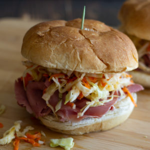 Corned beef sandwiches with slaw on rolls.