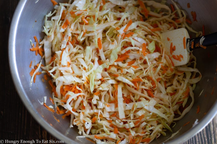 cabbage and carrot slaw in a stainless steel bowl.