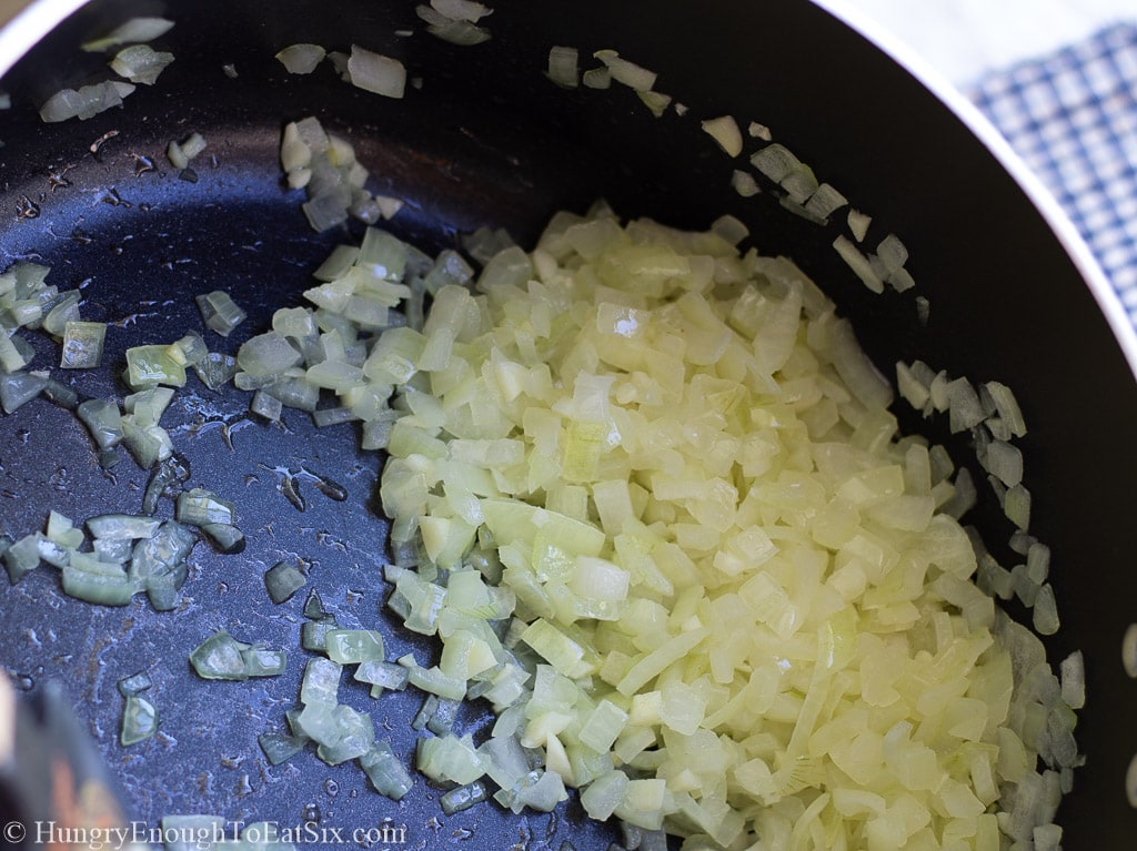Diced onion cooking in a pan