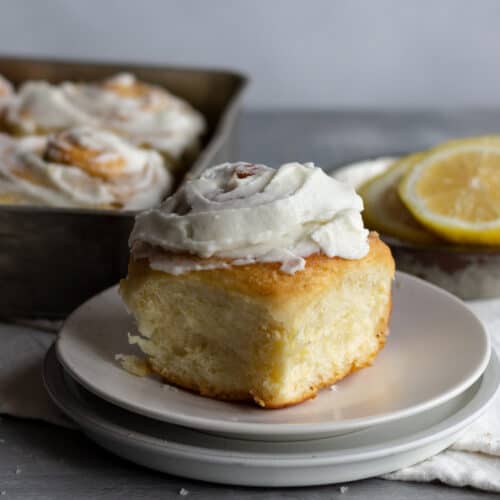 Frosted lemon roll on a plate.