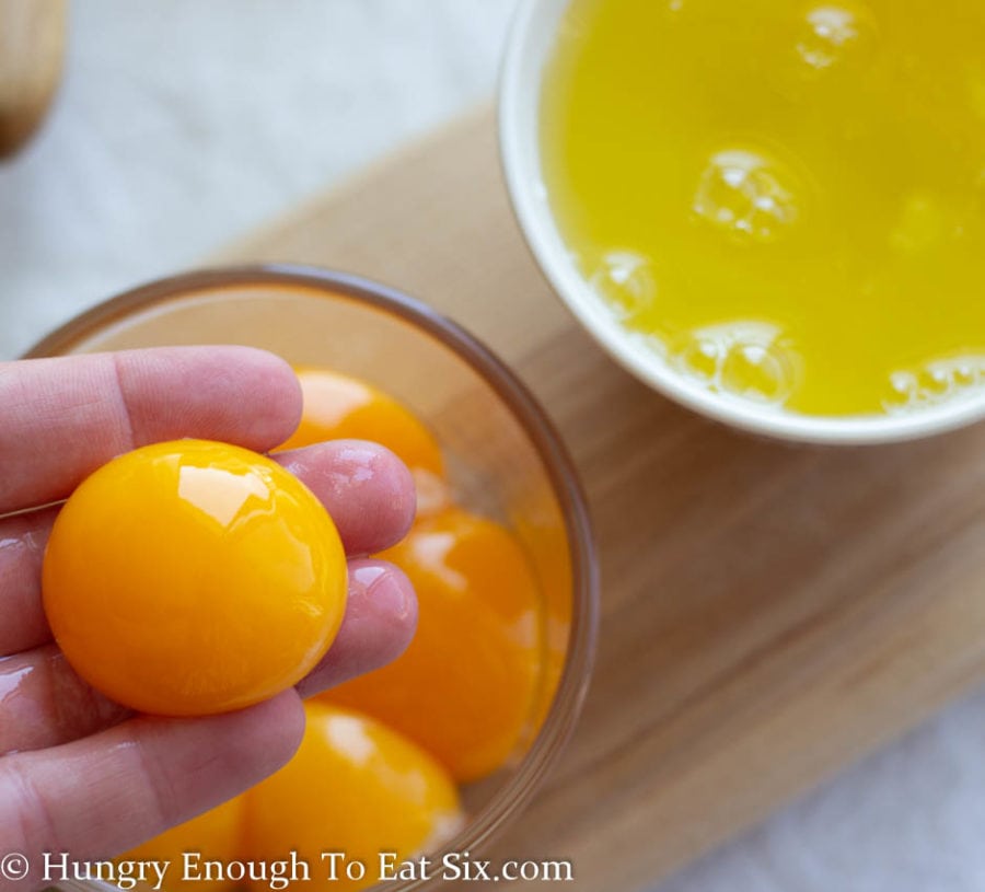 Egg yolk separated in a bowl, whites in a separate bowl.