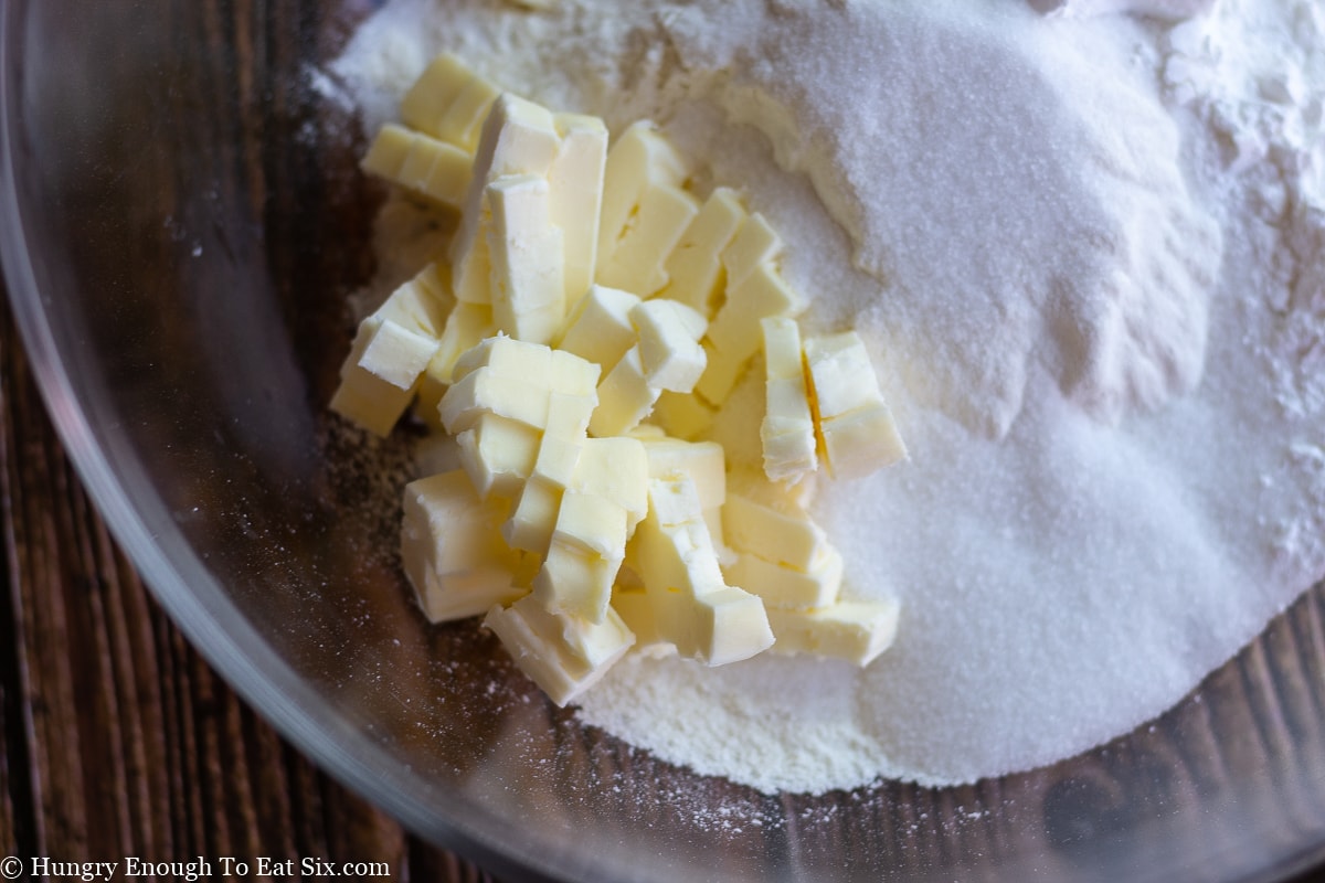 Cubed butter in a bowl with flour and sugar.