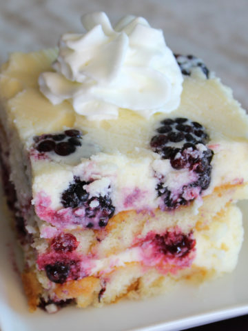 Slice of icebox cake with blackberries and whipped cream
