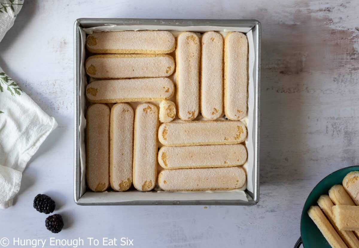 Ladyfingers arranged in a square pan.