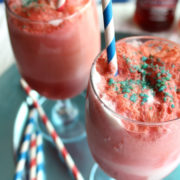 Red ice cream sodas with striped paper straws.