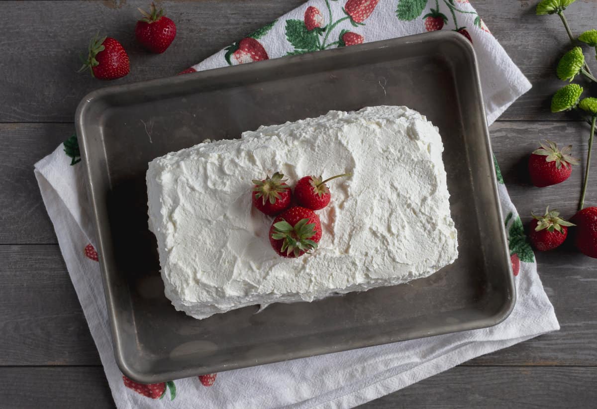 Whipped cream frosted loaf-shaped cake