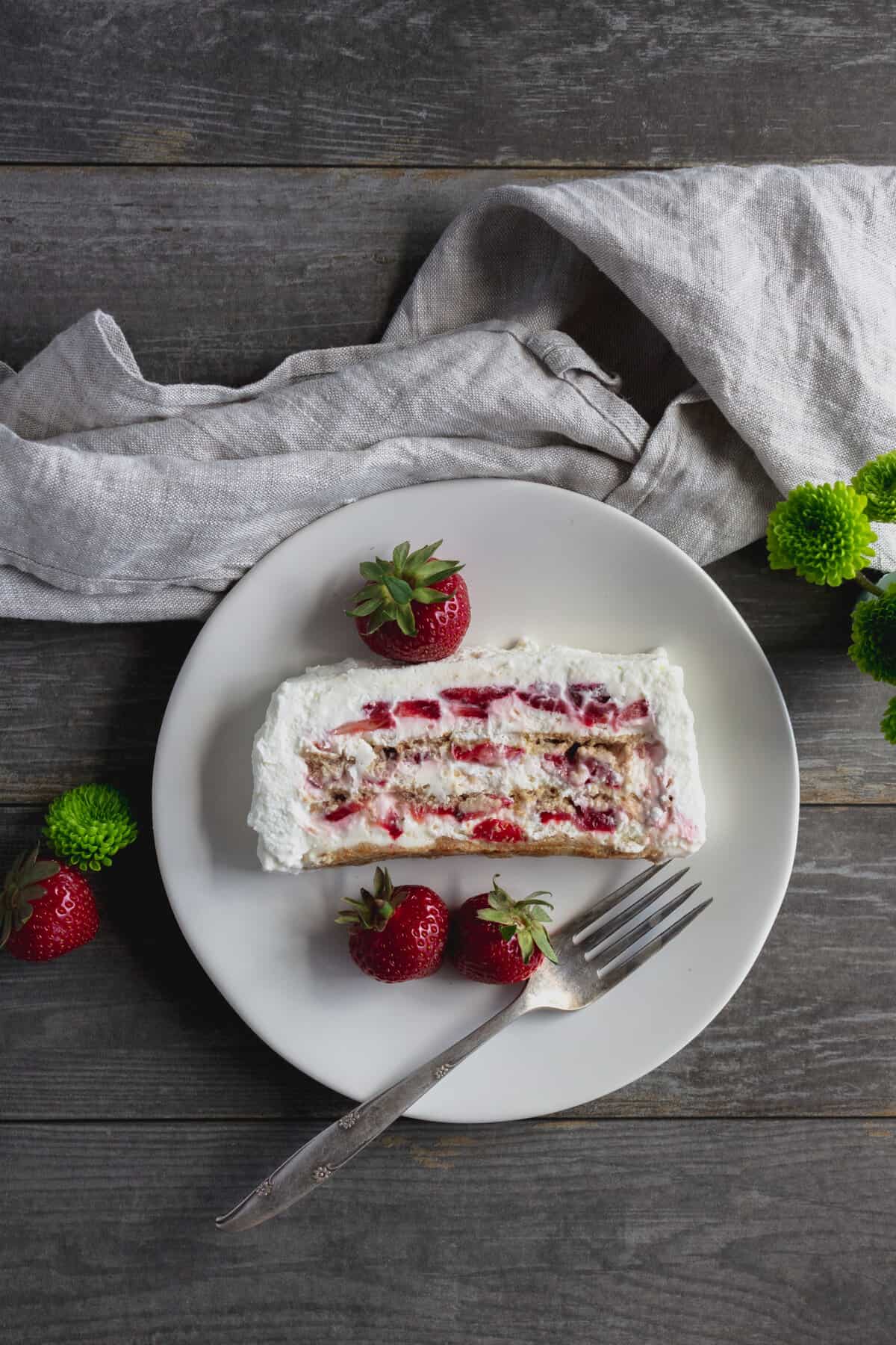 Strawberry icebox cake with fork and berries