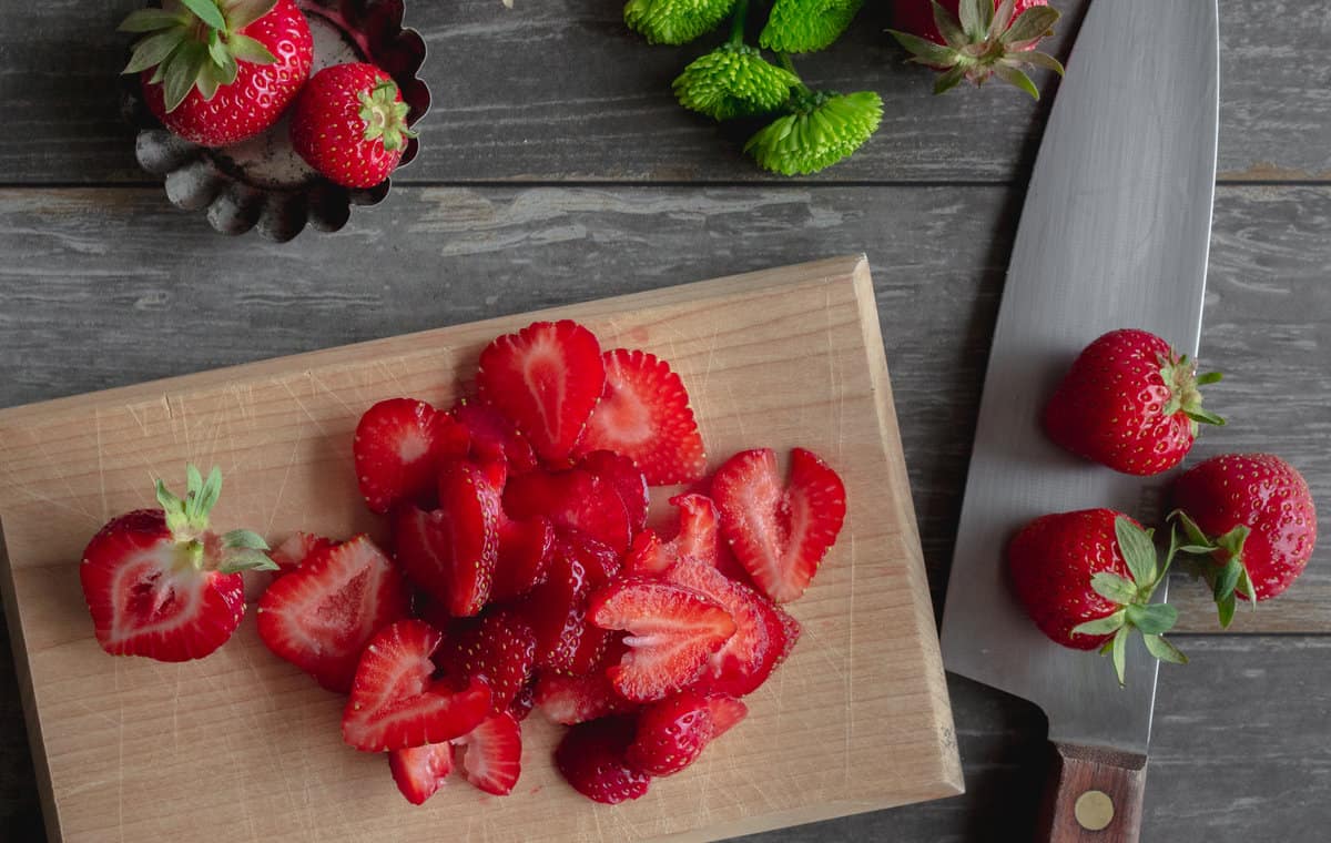 Sliced strawberries on a cutting board