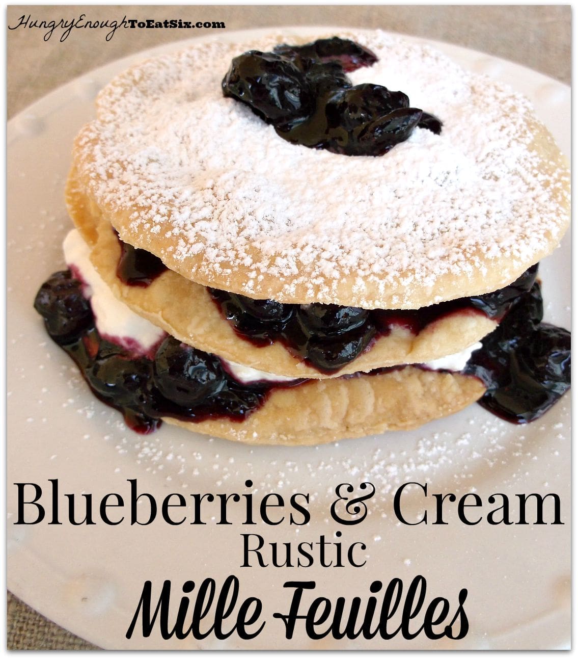 Stack of pastry, blueberries and cream