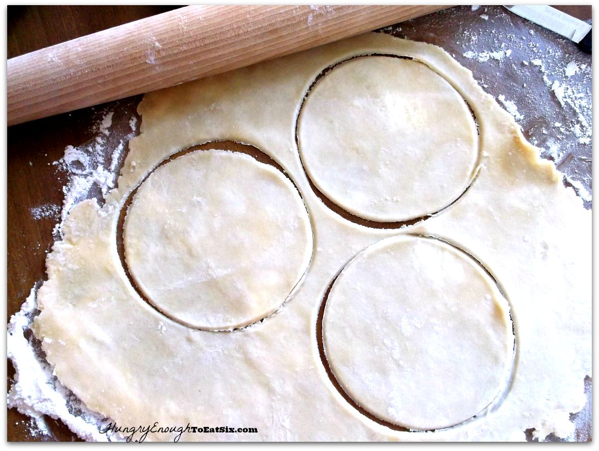 Rolled out pastry dough with three circle cut into the dough
