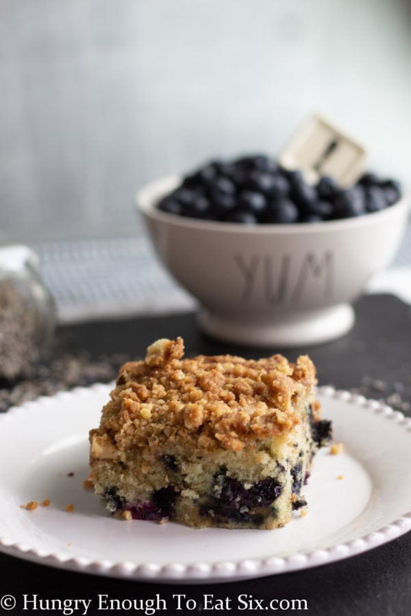 White plate holding a slice of coffee cake.
