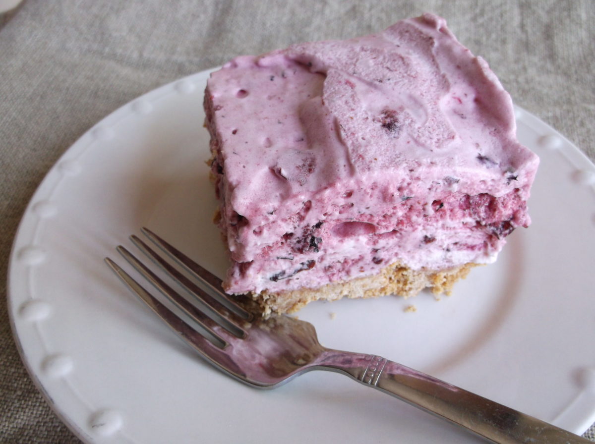 Slice of berry fluff cake on plate