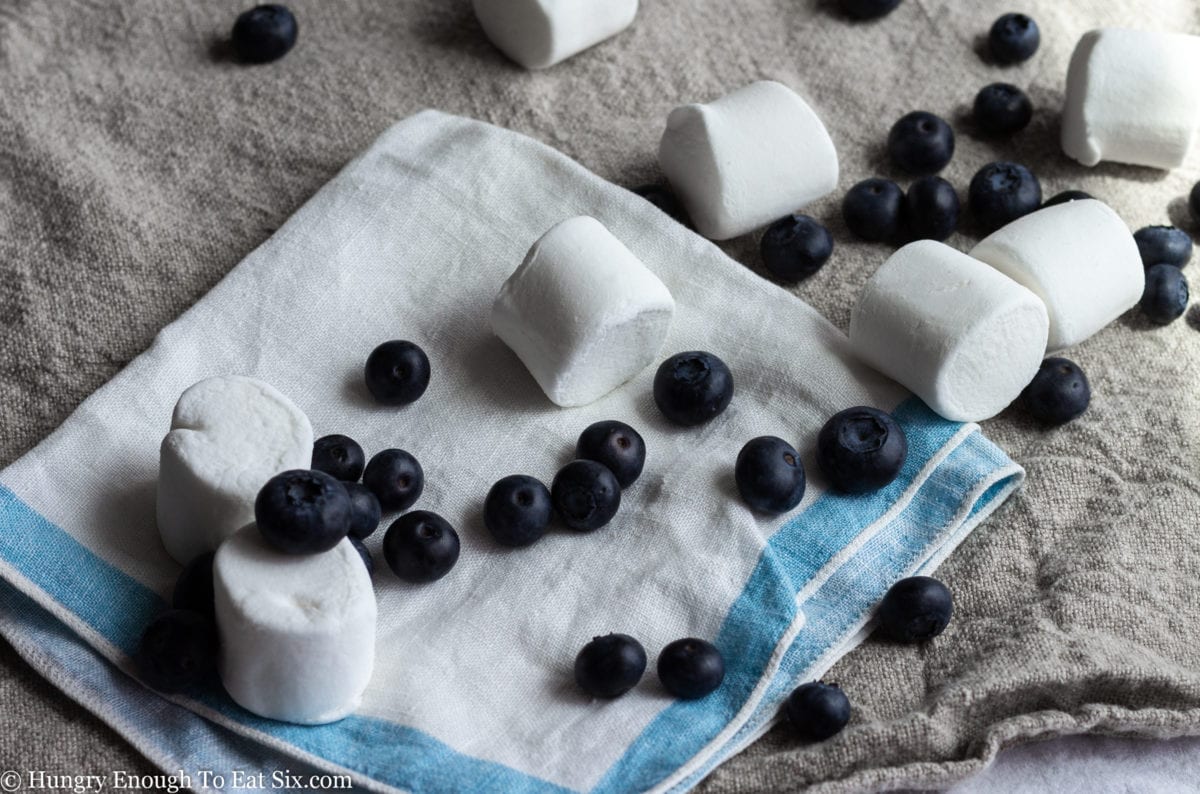 Blueberries and marshmallows on a white cloth