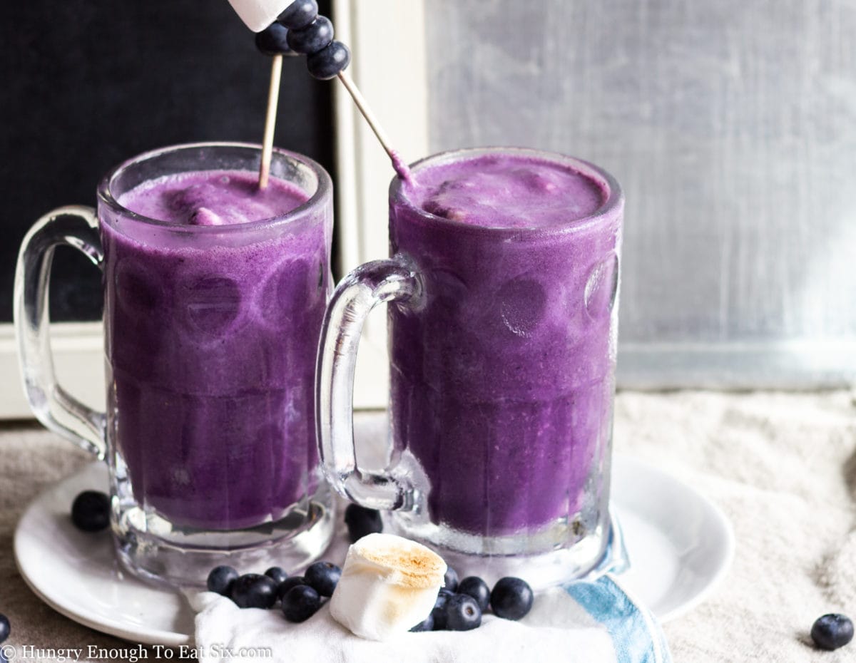 Blueberry milkshakes in glass mugs
