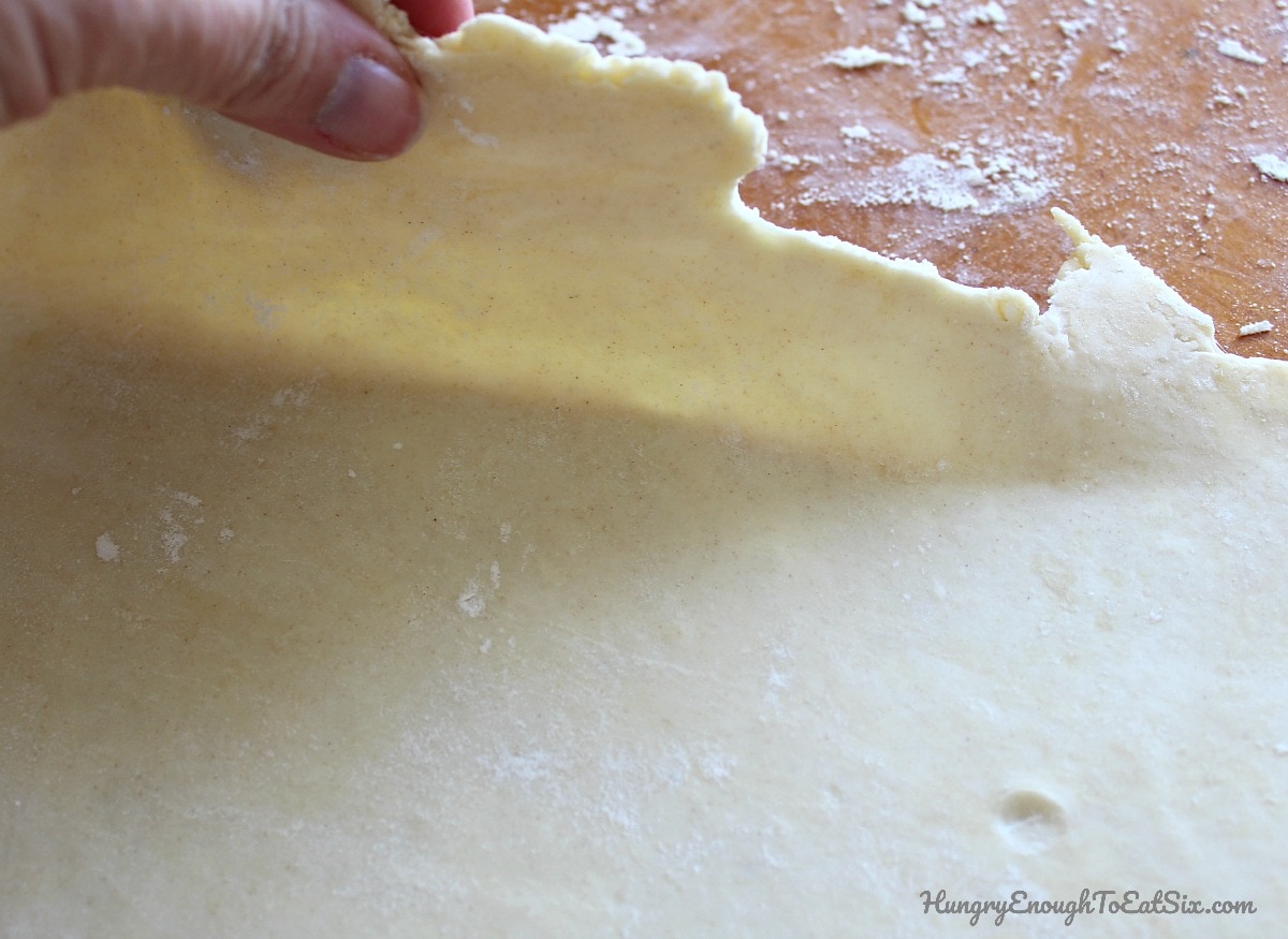 Lifting the edge of rolled out pie dough