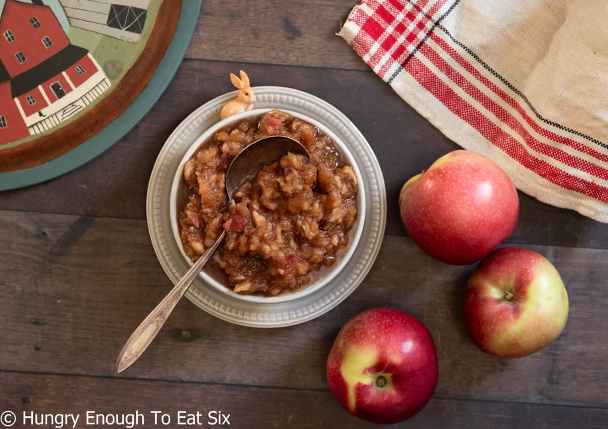 Apples and country decor with a dish of homemade applesauce.