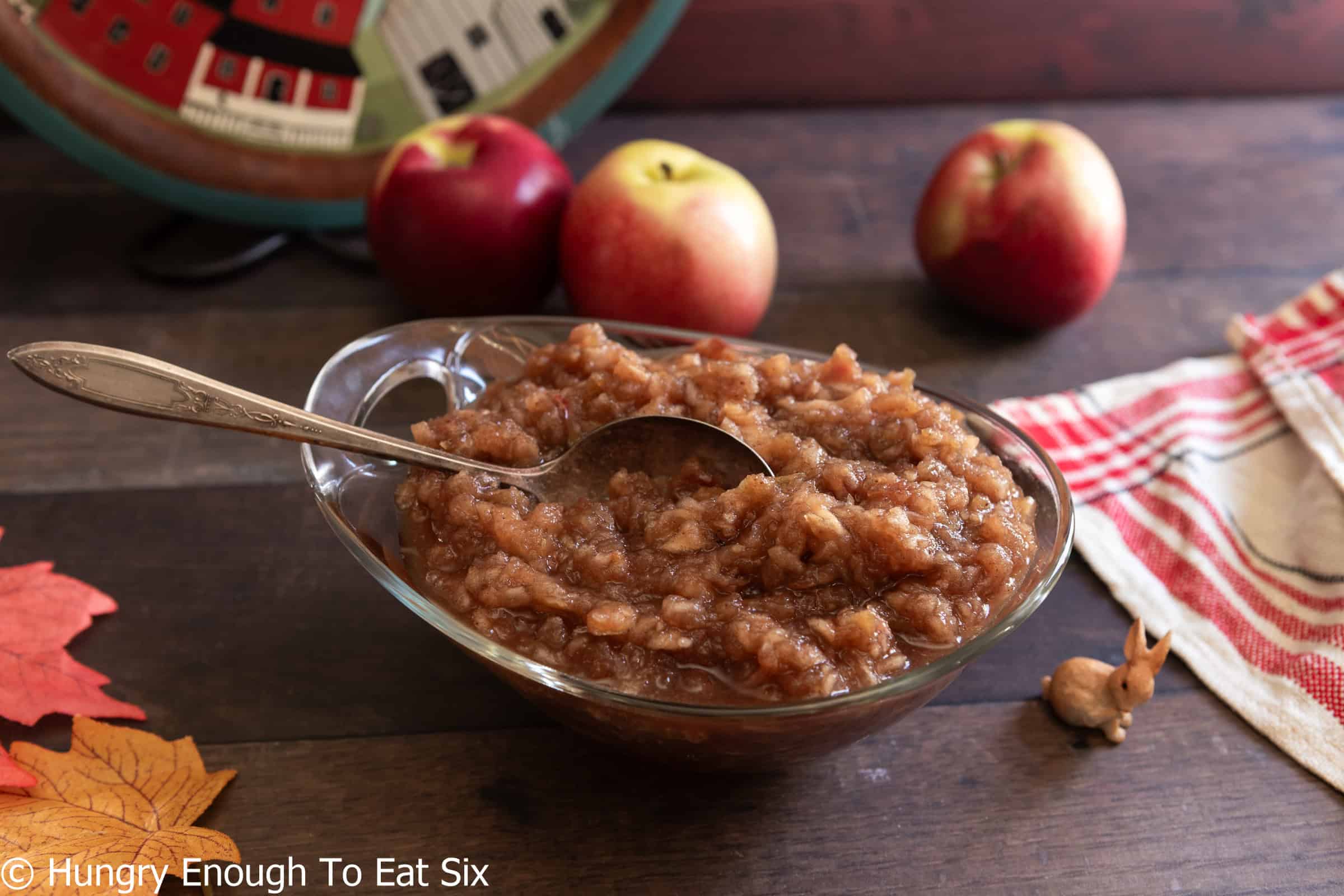 Large glass bowl of homemade applesauce with a spoon.