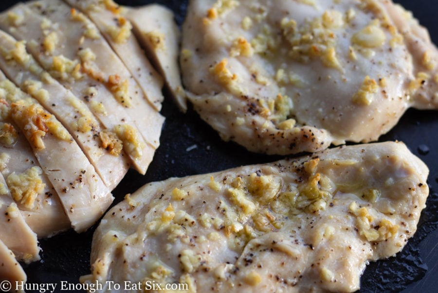 Cooked chicken breasts with olive oil and garlic.