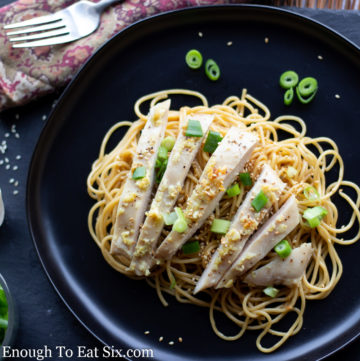 Sliced chicken and scallions on top of sesame noodles.