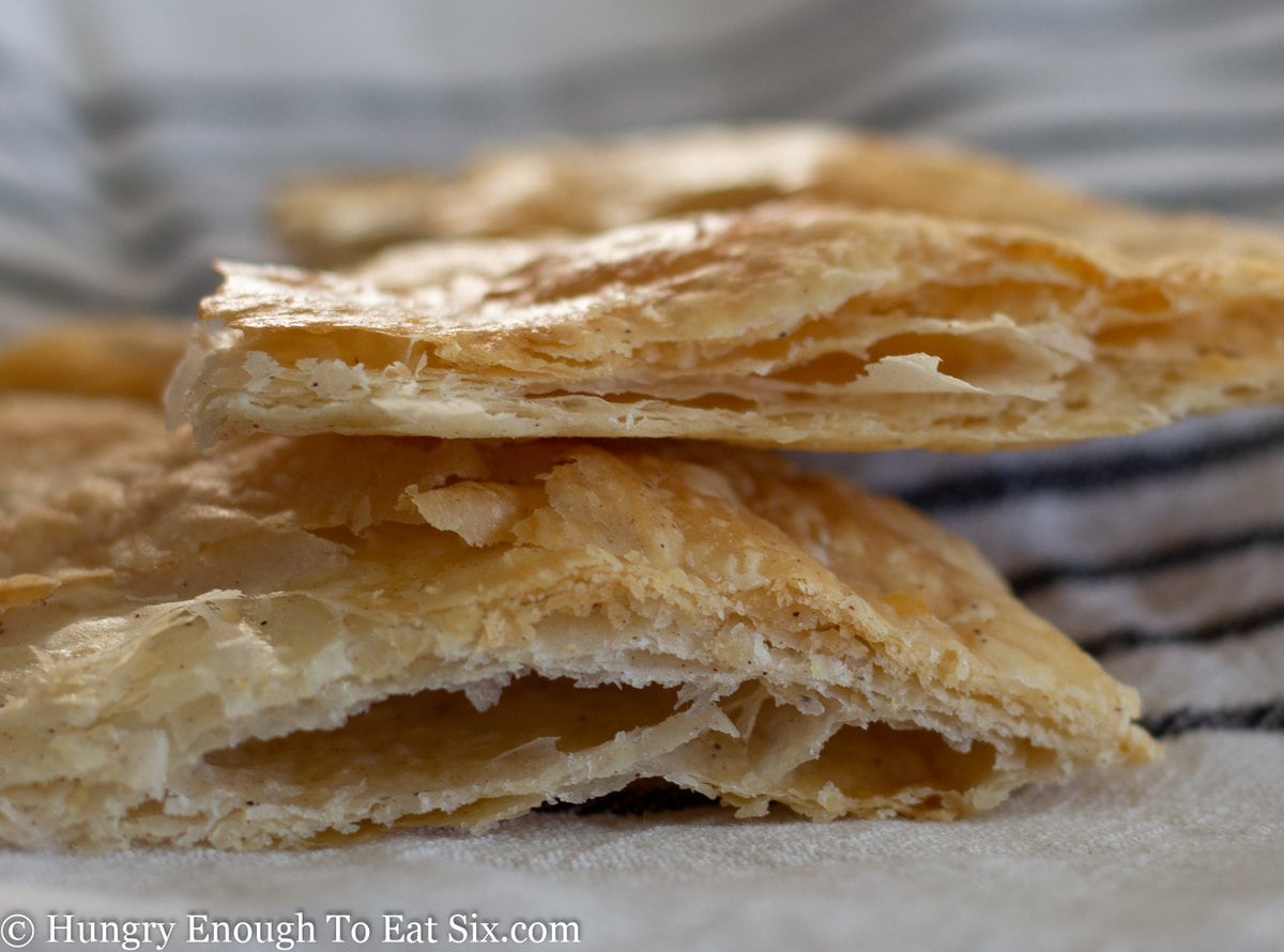 Baked pieces of flaky pie crust showing the layers