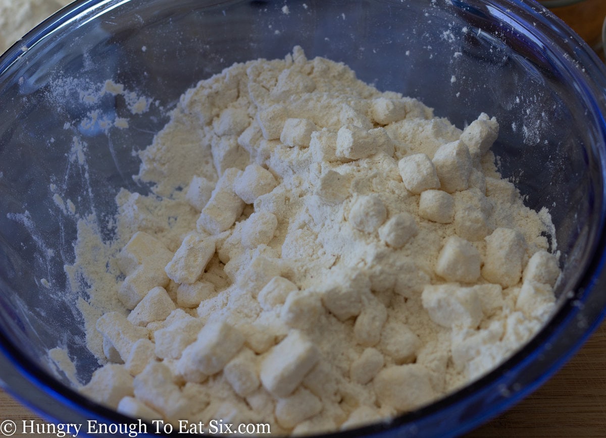 Cubes of butter coated in flour in a blue bowl