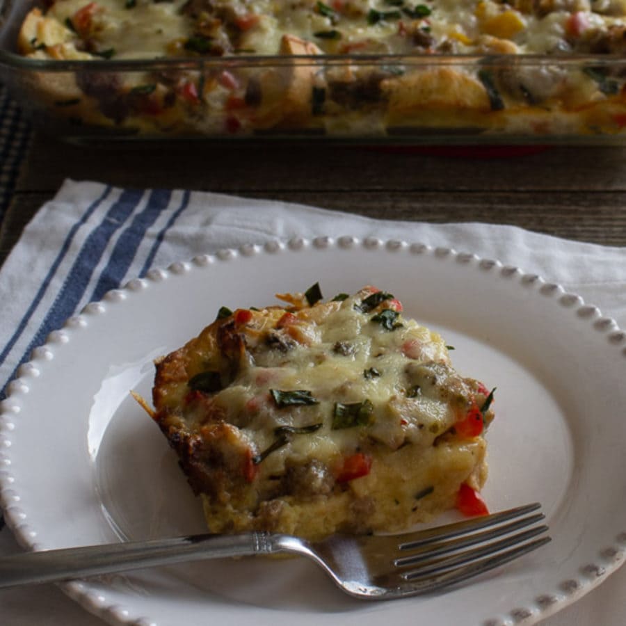 Square of egg breakfast casserole on a white plate.