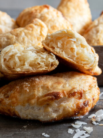 Flaky small pastries with one opened to show filling.