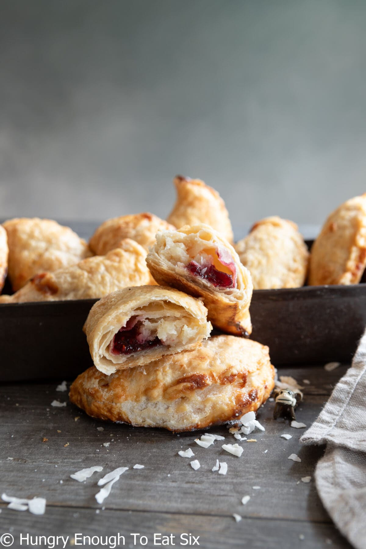 Coconut and raspberry jam pastry opened to show filling.