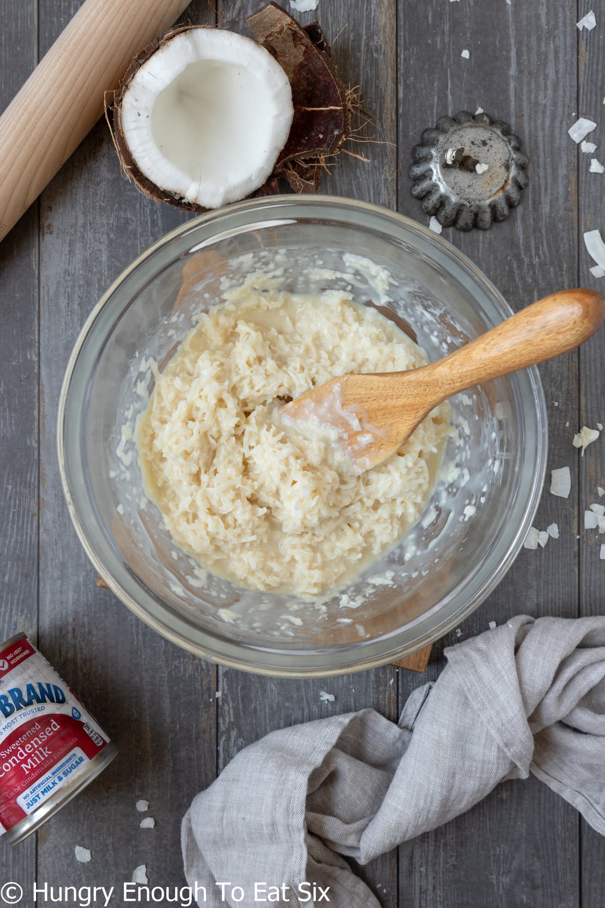 Bowl with creamy coconut mixture and wooden spoon.