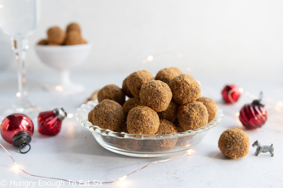 Small clear glass plate with several ginger cookie chocolate truffles.