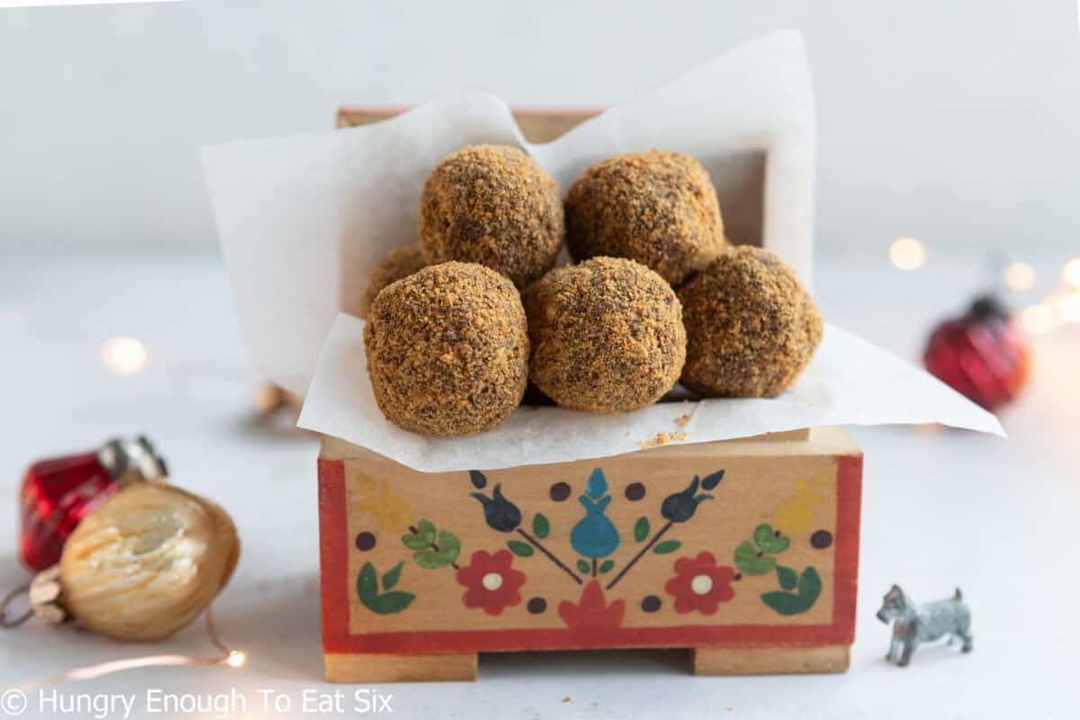 Small decorated box holding white paper and ginger cookie chocolate truffles.
