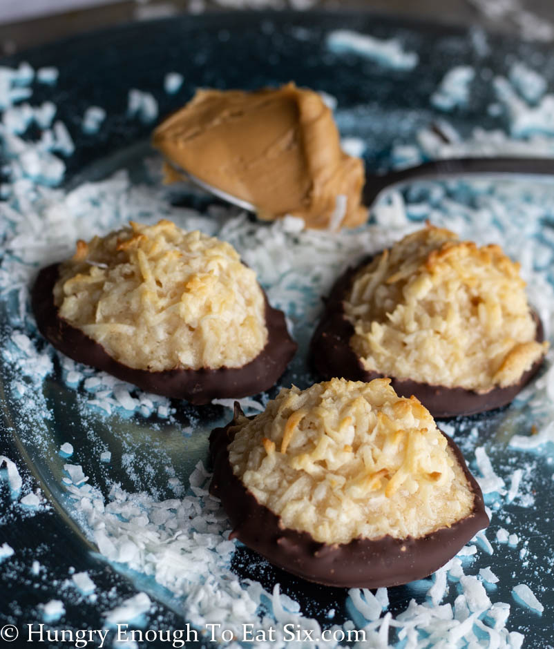 Coconut macaroons next to a spoonful of peanut butter