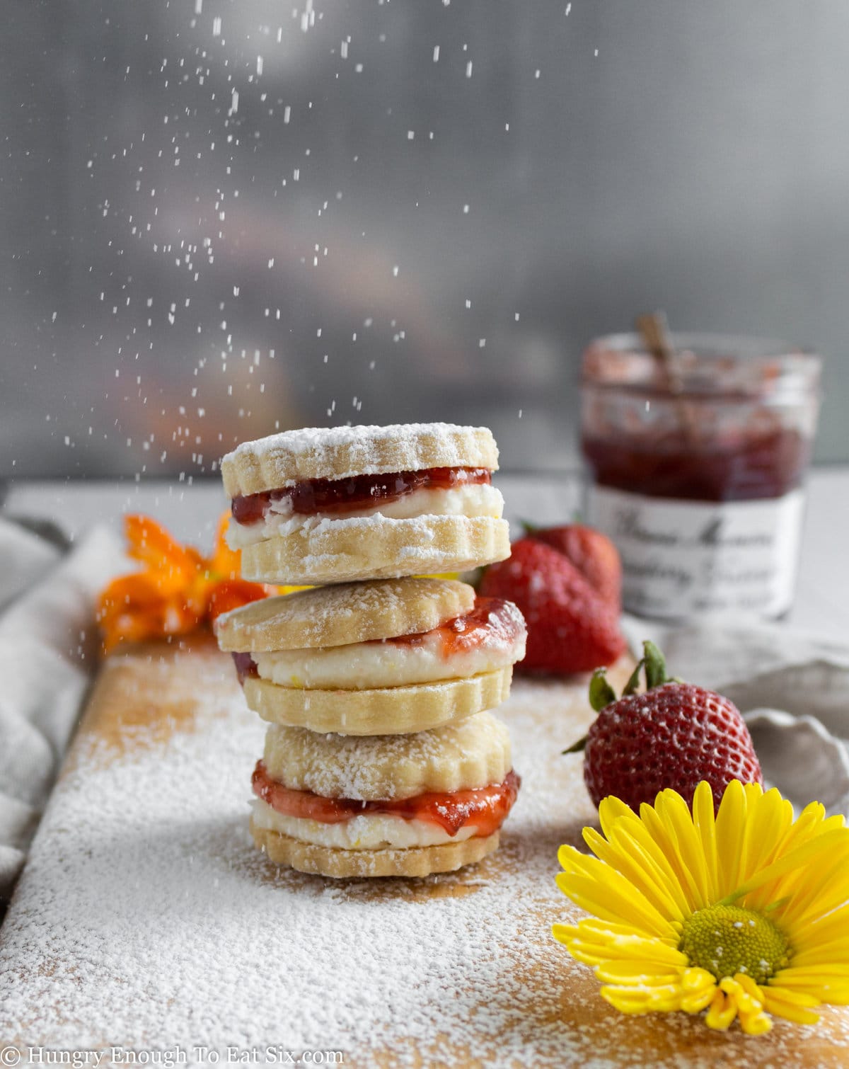 Stack of cookies with strawberries and flowers