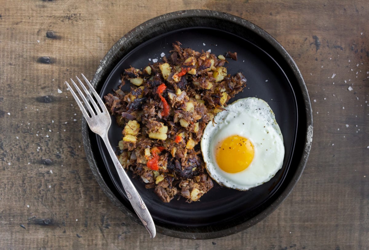 Beef hash and fried egg with fork