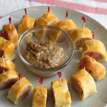 Circle of toothpick skewered sausage pieces on a plate