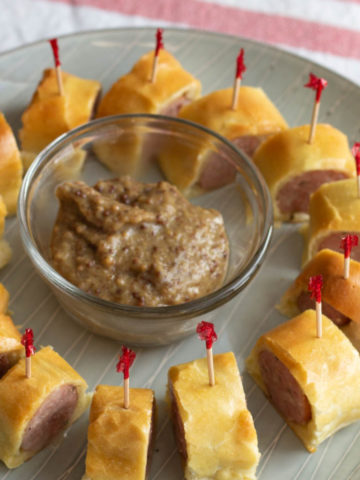 Circle of toothpick skewered sausage pieces on a plate