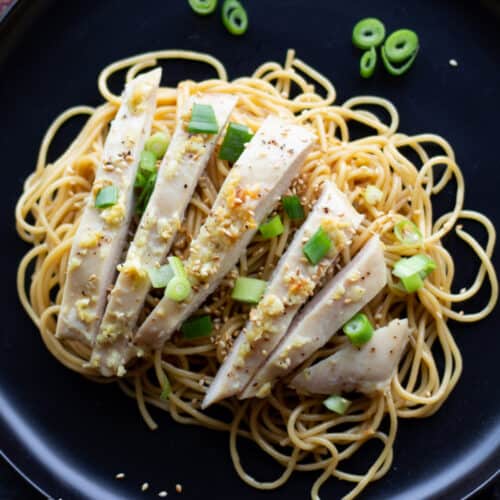Sliced chicken with noodles and scallions.